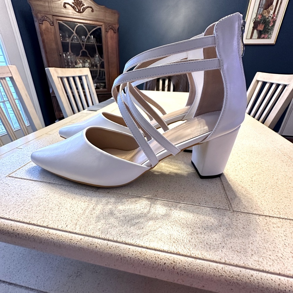 Unbranded white heels with crisscross ankle straps. Size 10 or EU42